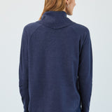 Person wearing a navy blue sweater on a white background