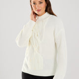 This cable knit sweater features delicate pearl embellishments, adding a touch of sophistication to a classic design.