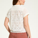 This 100% cotton top exudes effortless style with its eyelet lace detailing and playful tie at the front. A versatile choice for any casual occasion.