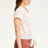 This 100% cotton top exudes effortless style with its eyelet lace detailing and playful tie at the front. A versatile choice for any casual occasion.