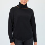 Woman wearing a black turtleneck sweater against a white background