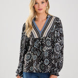 This boho blouse combines feminine flair with a touch of vintage-inspired style for a truly unique piece.