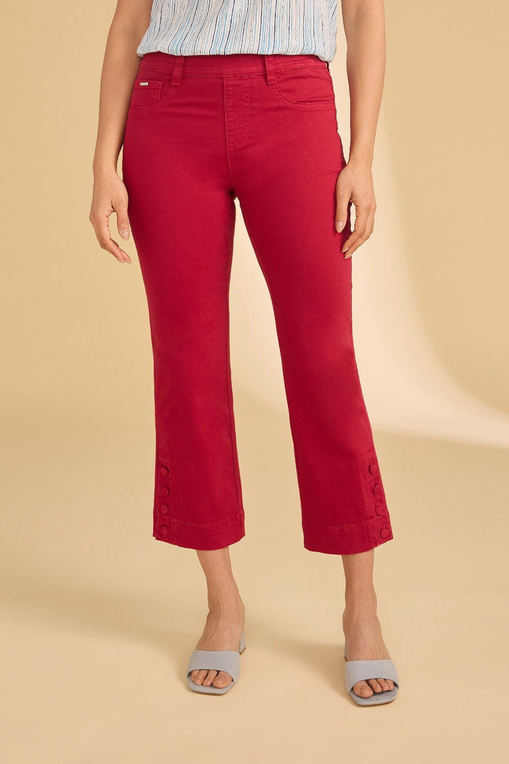 Person wearing red pants on a beige background