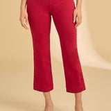 Person wearing red pants on a beige background