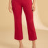 Person wearing red pants on a beige background