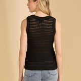 Woman wearing a black sleeveless top with a unique back design on a beige background