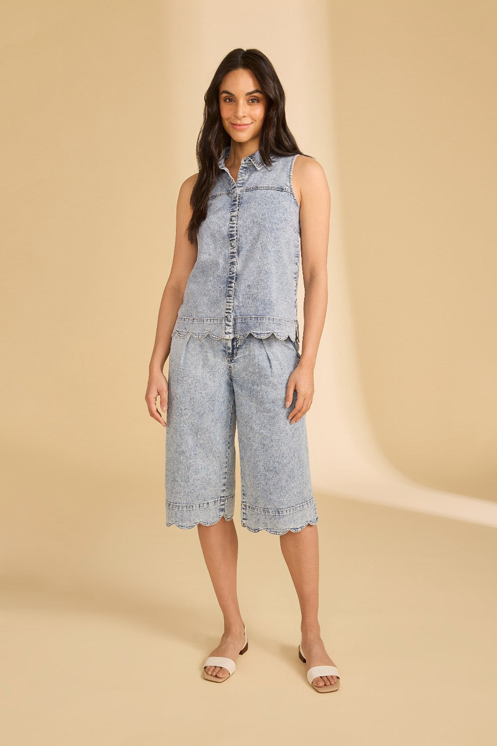 Woman wearing a denim outfit on a beige background