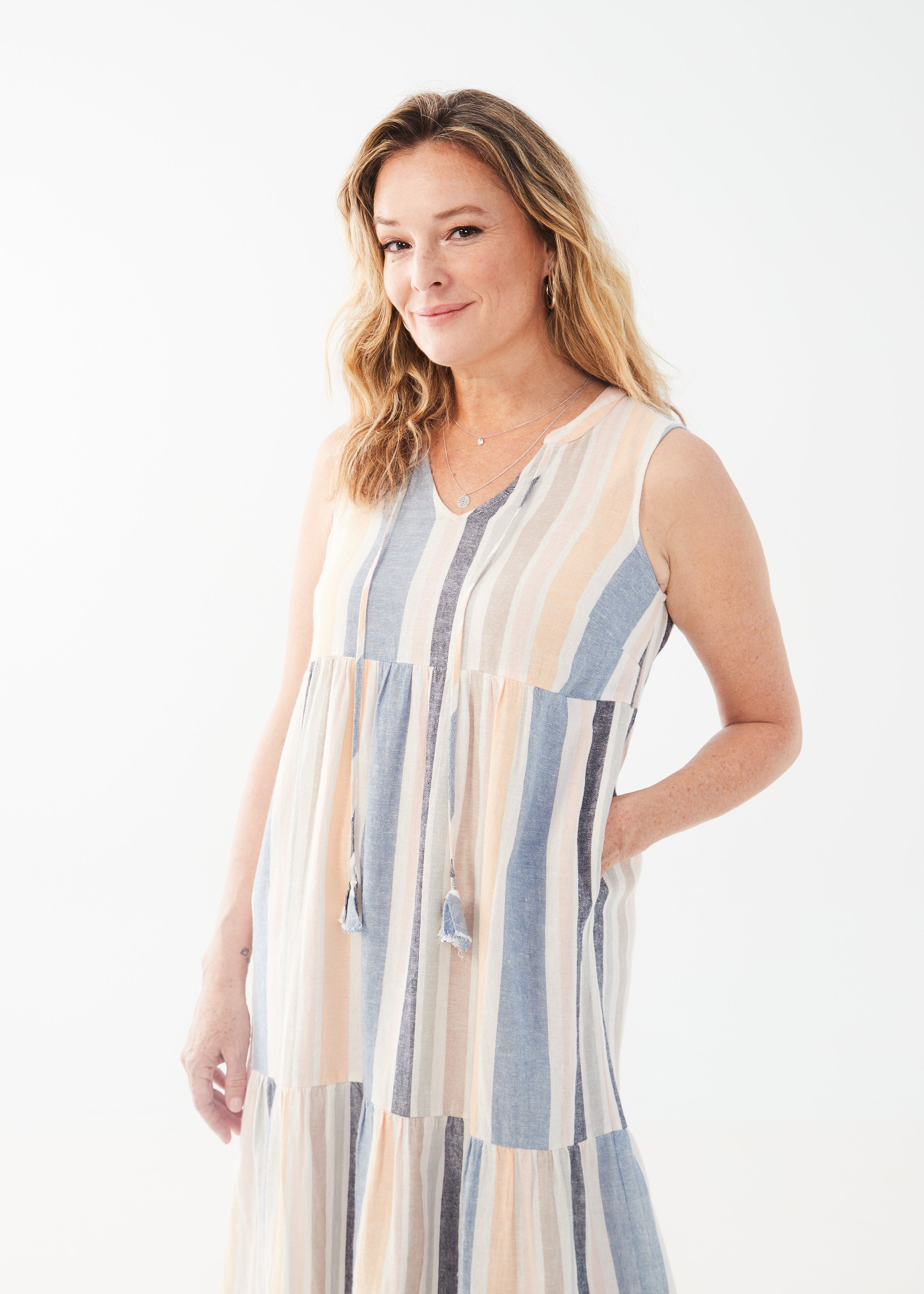 Stay stylish and comfortable in our FDJ Sleeveless Tiered Midi Dress. Perfect for summer with its baha stripe design and linen blend fabric. Plus, it has pockets for added convenience!