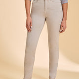 Person wearing grey jeans with a multi coloured shirt against a beige background