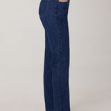 Person wearing blue jeans on a plain background