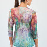 Woman wearing a colorful tie-dye shirt on a white background