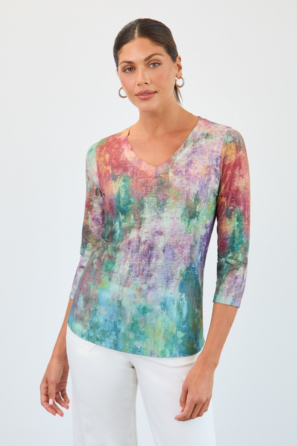 Woman wearing a colorful tie-dye shirt on a white background