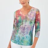 Woman wearing a colorful tie-dye shirt on a white background