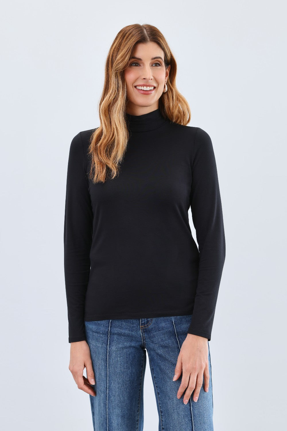 The FDJ Long Sleeve Mock Neck Top is a classic, basic layering piece designed to complement any wardrobe. Its simple yet elegant style makes it perfect for layering under jackets or wearing alone for a clean, polished look. Comfortable and versatile, it’s an essential addition to your everyday collection.