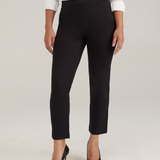 A model wearing black cropped trousers, a white textured blouse, and black high heels, standing against a light gray studio background.