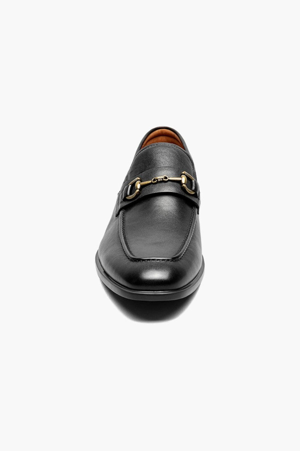 Black leather loafer with gold buckle on a white background