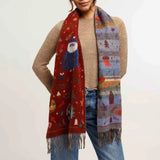 Woman wearing Christmas themed scarf with beige sweater and blue jeans on light background