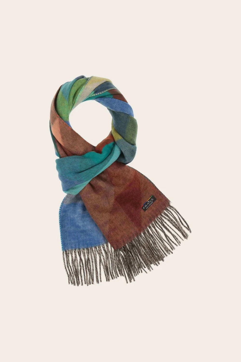 Colorful scarf with fringes on a beige background