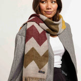 Woman wearing a patterned scarf with a plain background