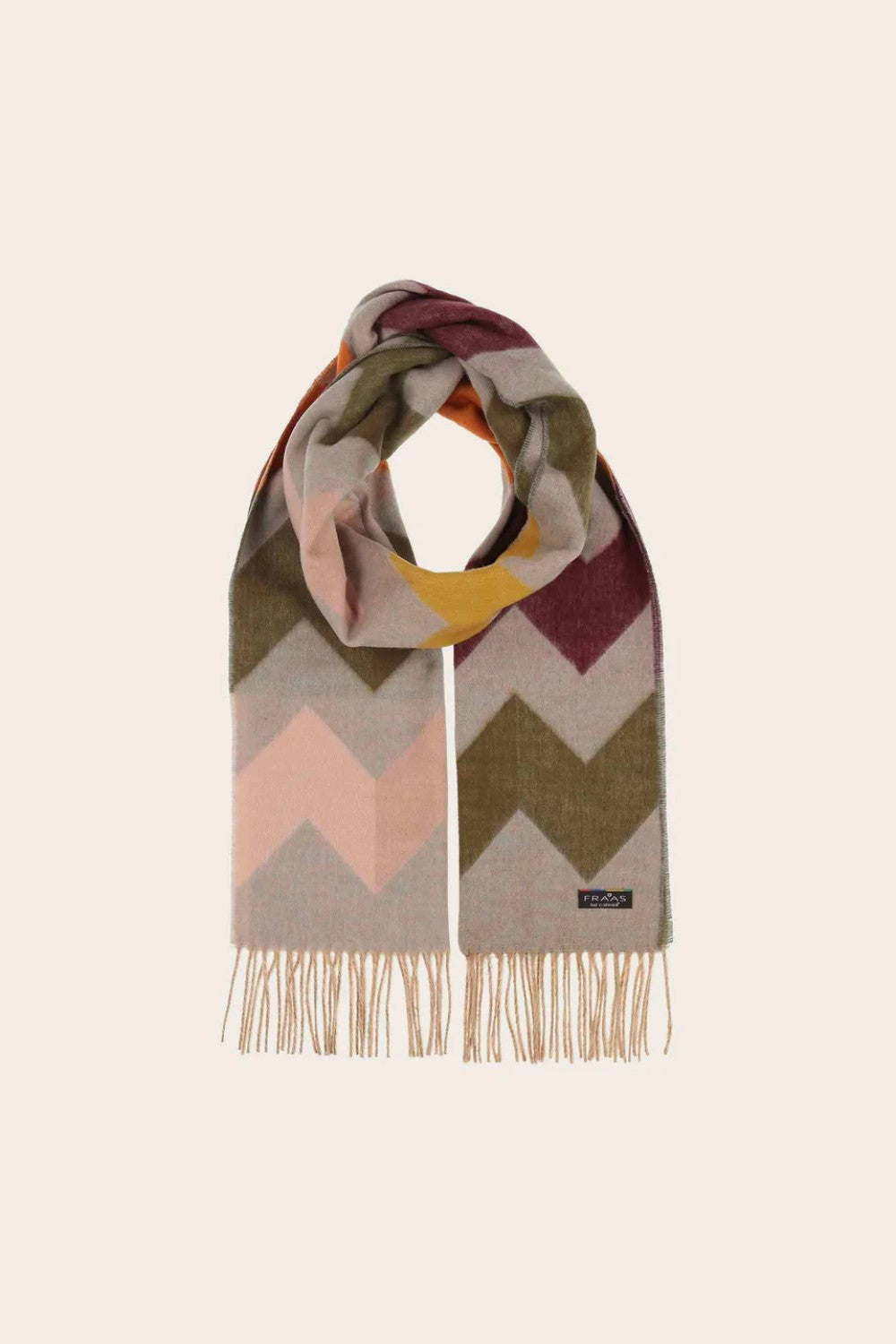 Multicolored zigzag patterned scarf with fringes on a beige background