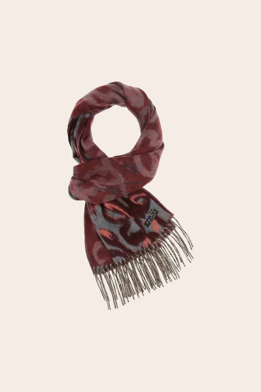 Patterned scarf with fringe on a beige background