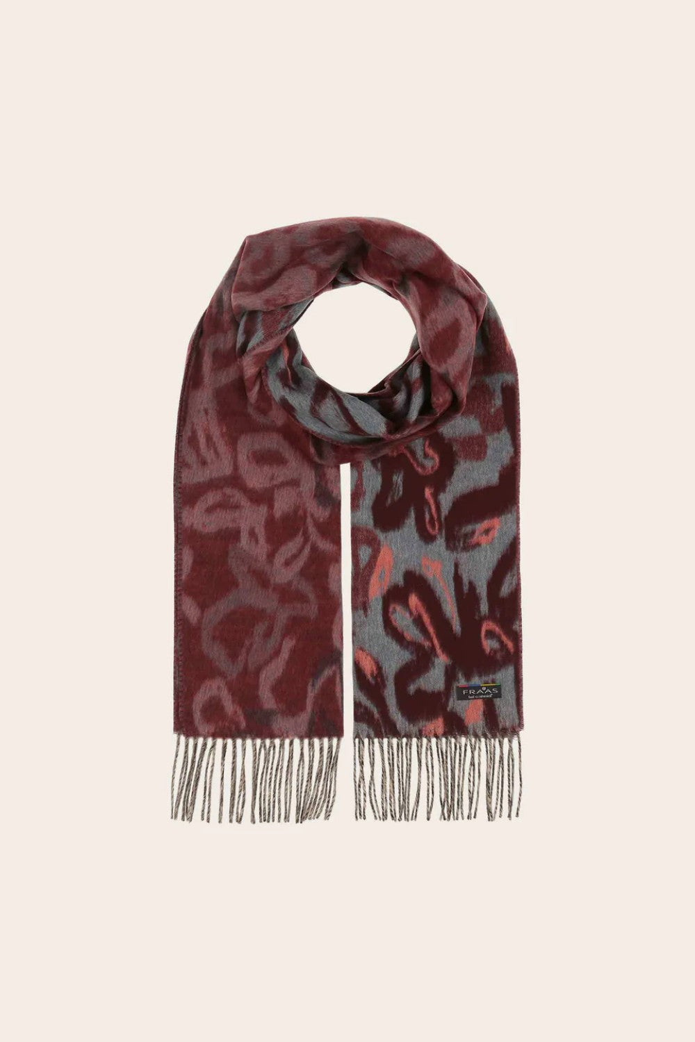 Patterned scarf with fringes on a beige background