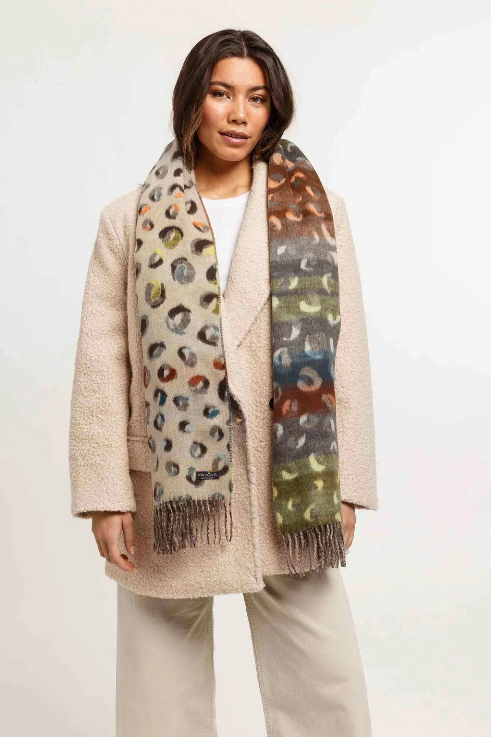 Woman wearing a patterned scarf with a neutral background