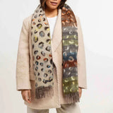 Woman wearing a patterned scarf with a neutral background