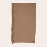 Brown scarf with fur trim on a beige background