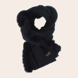 Black scarf with fluffy trim on a beige background