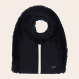 Black fur scarf with a brand label on a beige background