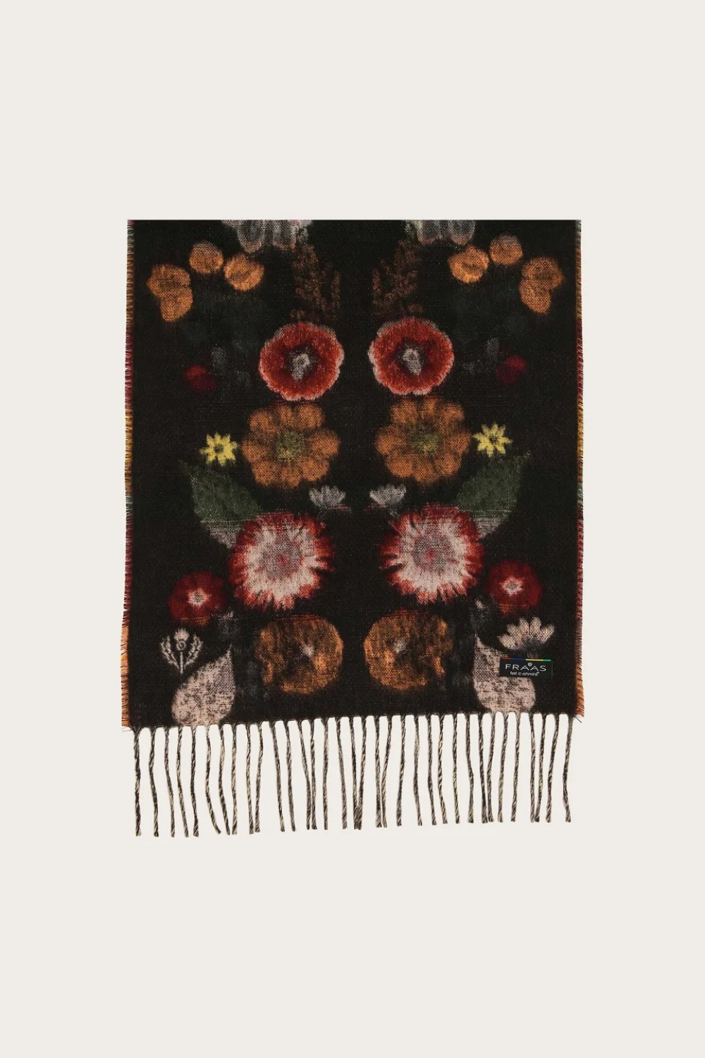 A black woven scarf with a detailed floral pattern in red, orange, yellow, and green, finished with fringe on one end, shown against a plain off-white background.