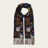 A dark navy scarf with a colorful floral pattern, finished with fringe at the ends, displayed against a solid off-white background.