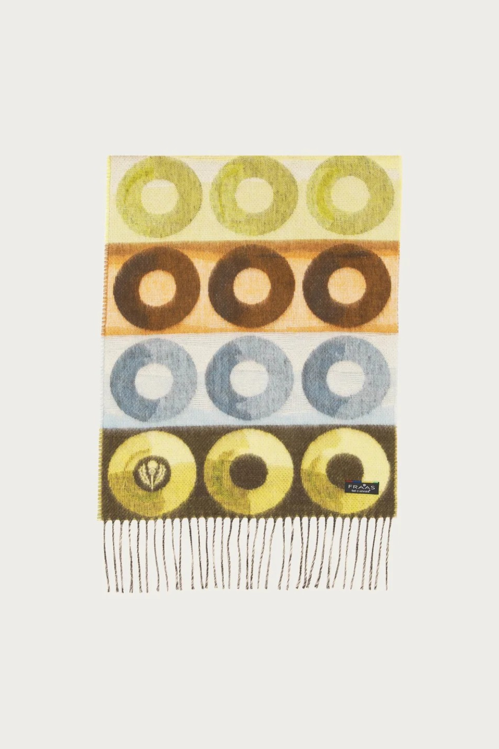 Scarf featuring a pattern with multi coloured circles and fringe photographed against a light background.