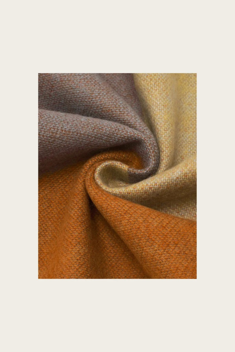 Close up of a multi coloured fabric photographed against a light backdrop.