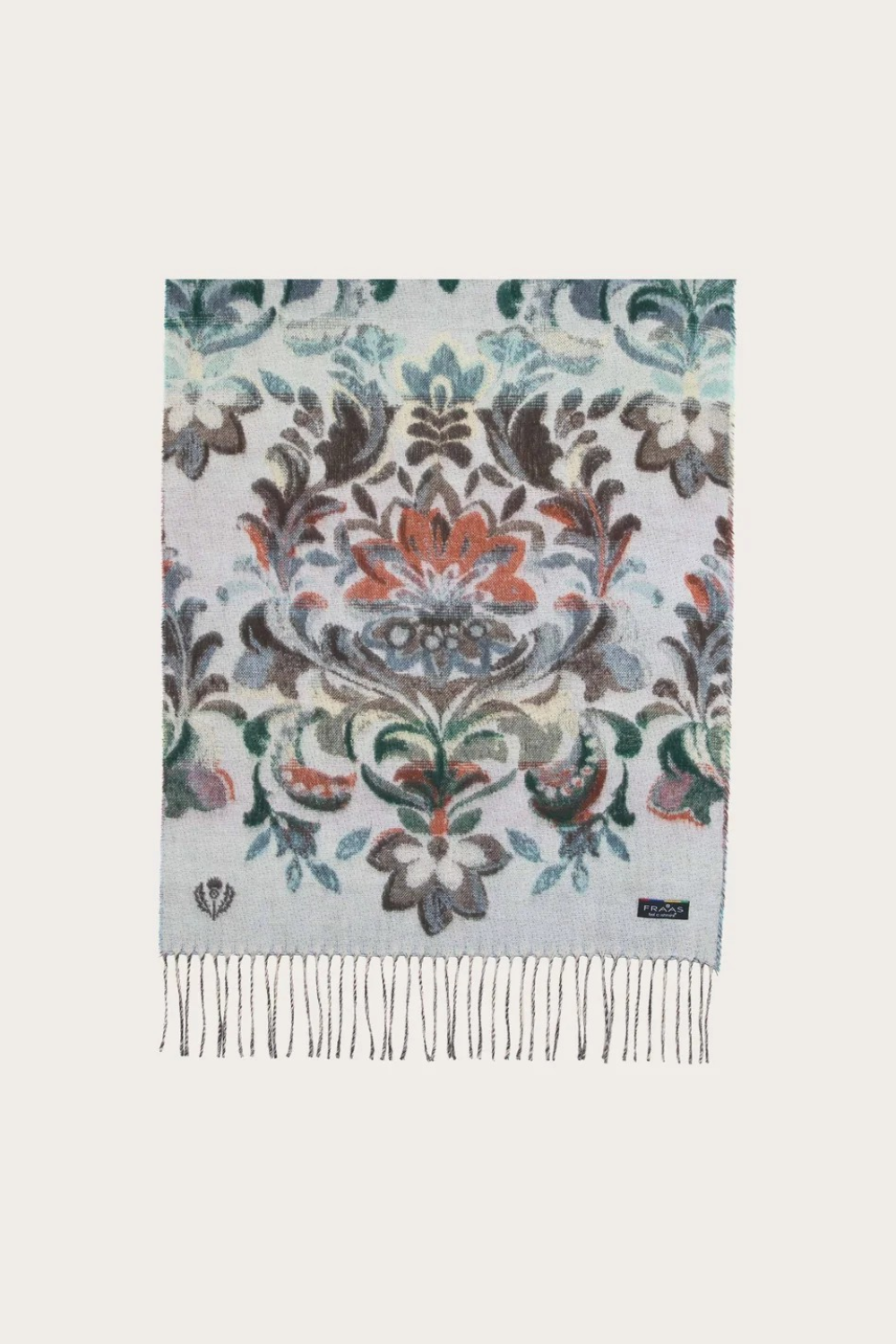 A multi coloured floral scarf, with fringe, photographed against a light background.