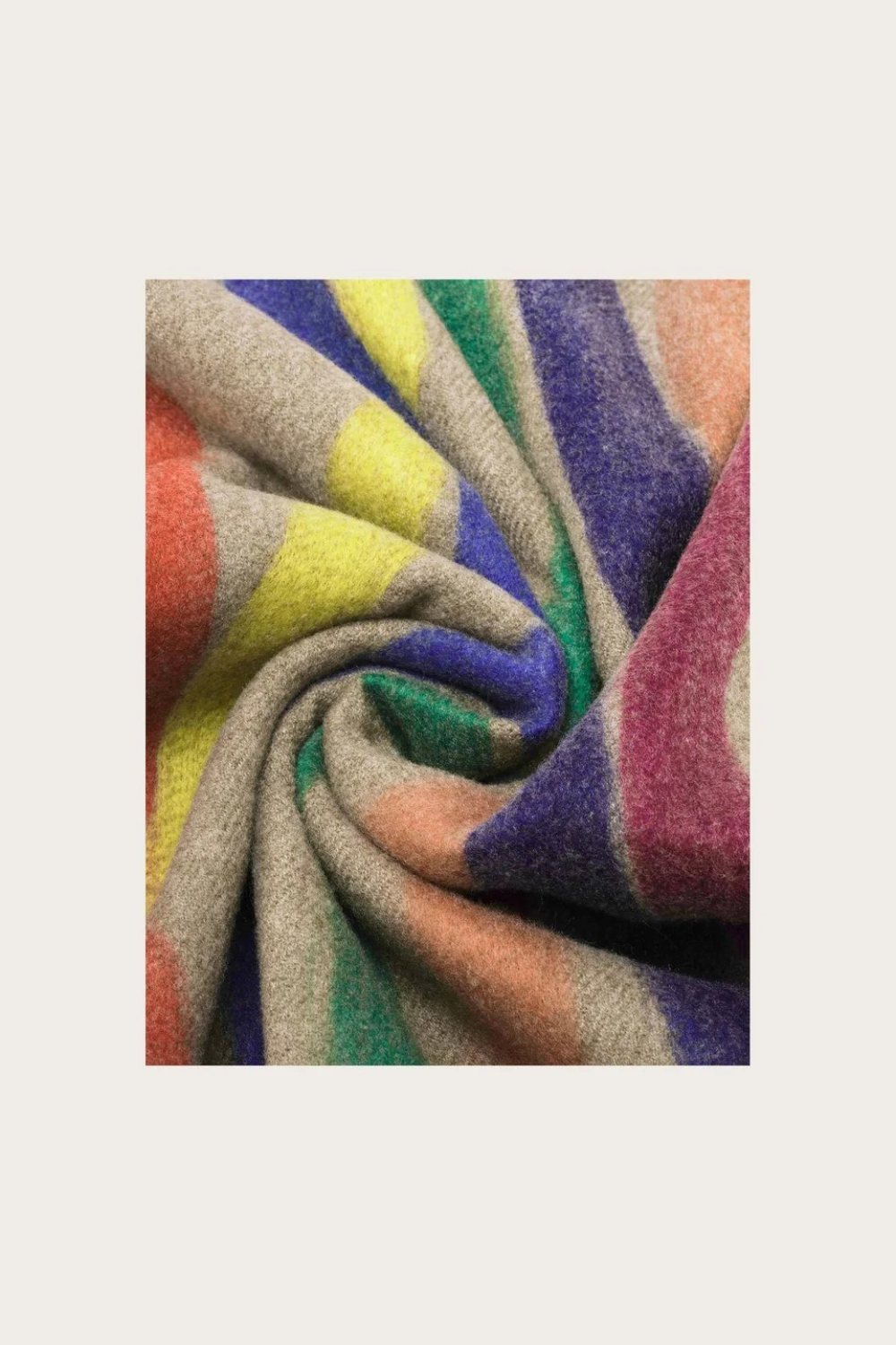 A beige based scarf with multi coloured brushstoke patterns photographed against a light backdrop.