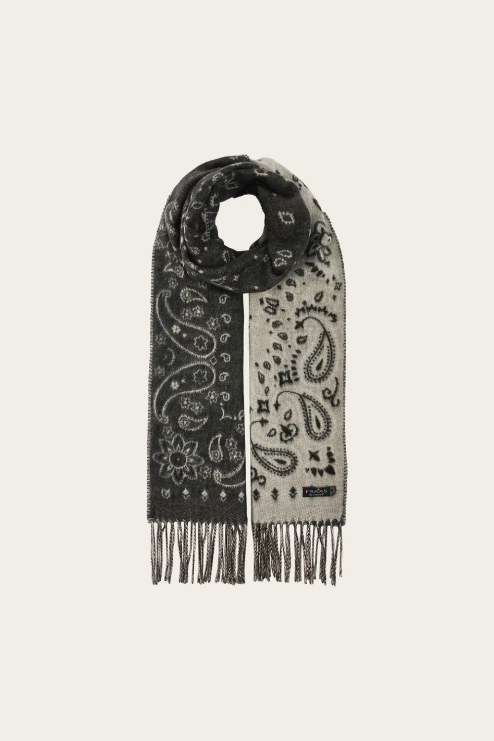 A grey and paisley scarf, with fringe, photographed against a light background.