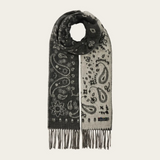 A grey and paisley scarf, with fringe, photographed against a light background.