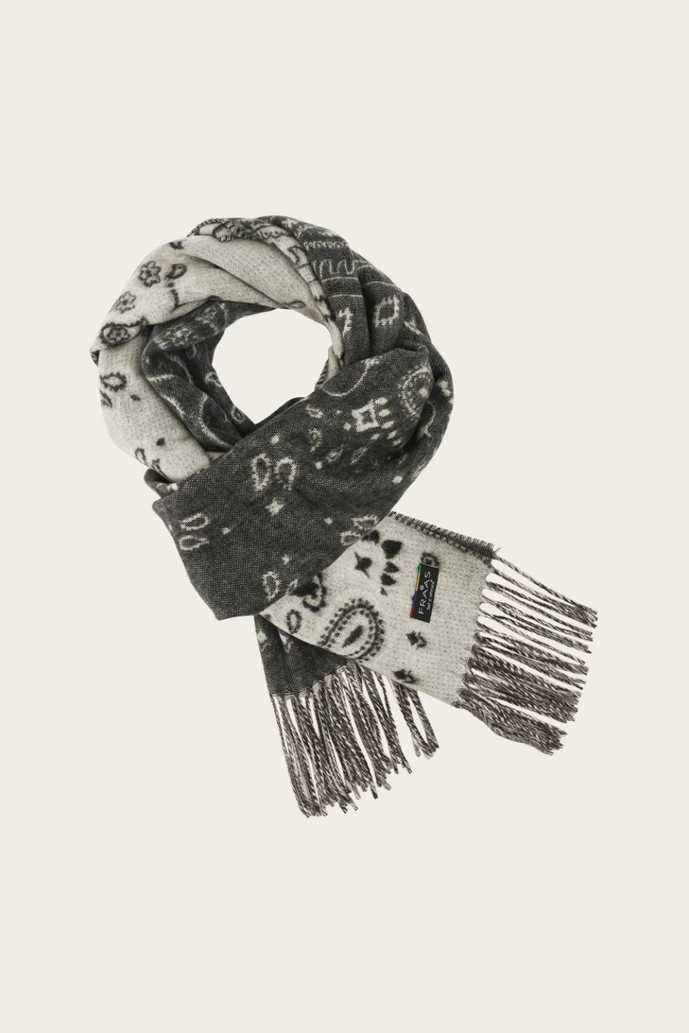 A grey and paisley scarf, with fringe, photographed against a light background.