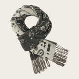 A grey and paisley scarf, with fringe, photographed against a light background.