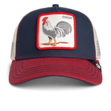 A navy blue and maroon trucker hat with a front patch featuring a rooster illustration and the word 'COCK'.