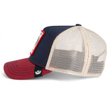 A classic trucker hat featuring a navy blue front panel, a cream mesh back, and a dark red curved brim. A small white embroidered logo is visible on the side of the brim.