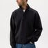 Man wearing a black jacket and blue jeans on a white background