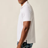 The ultimate poolside style, this terry polo harkens back to the day when lounging under a beach umbrella in the Hollywood Hills was a full-time job. It's made with a lighter version of the fabric used for ultra-luxe towels and it's made with a Johnny collar polo—a mark of the 60s worn by all your favorite style icons.