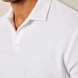 The ultimate poolside style, this terry polo harkens back to the day when lounging under a beach umbrella in the Hollywood Hills was a full-time job. It's made with a lighter version of the fabric used for ultra-luxe towels and it's made with a Johnny collar polo—a mark of the 60s worn by all your favorite style icons.