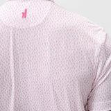 Person wearing a light pink patterned polo shirt with a small logo on the chest.