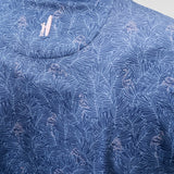 Close-up of a blue patterned shirt with a collar detail.