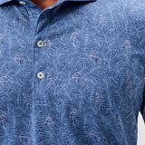 Close-up of a blue patterned shirt with buttons on a plain background