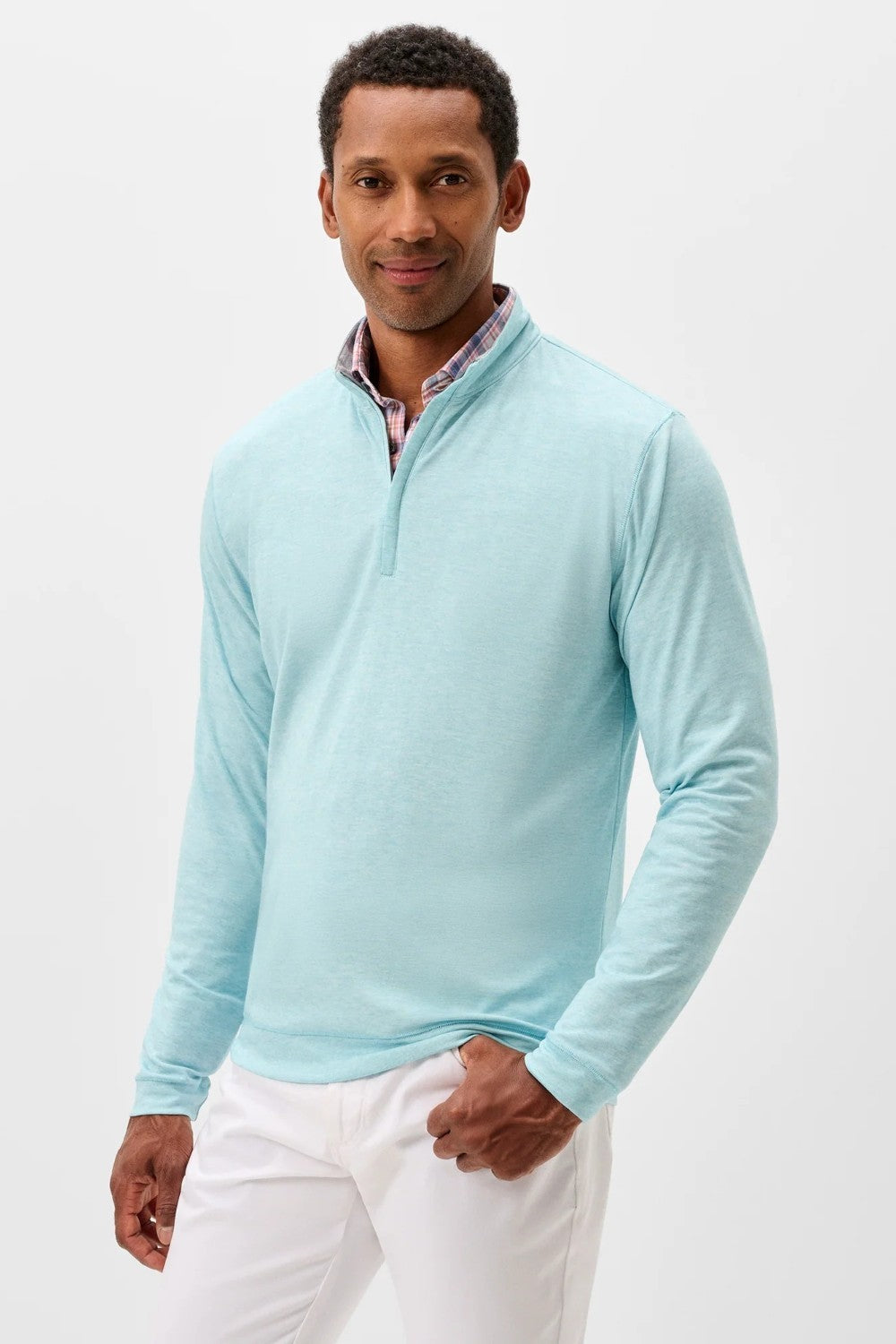 Man wearing a light blue long-sleeve shirt with a collar on a white background